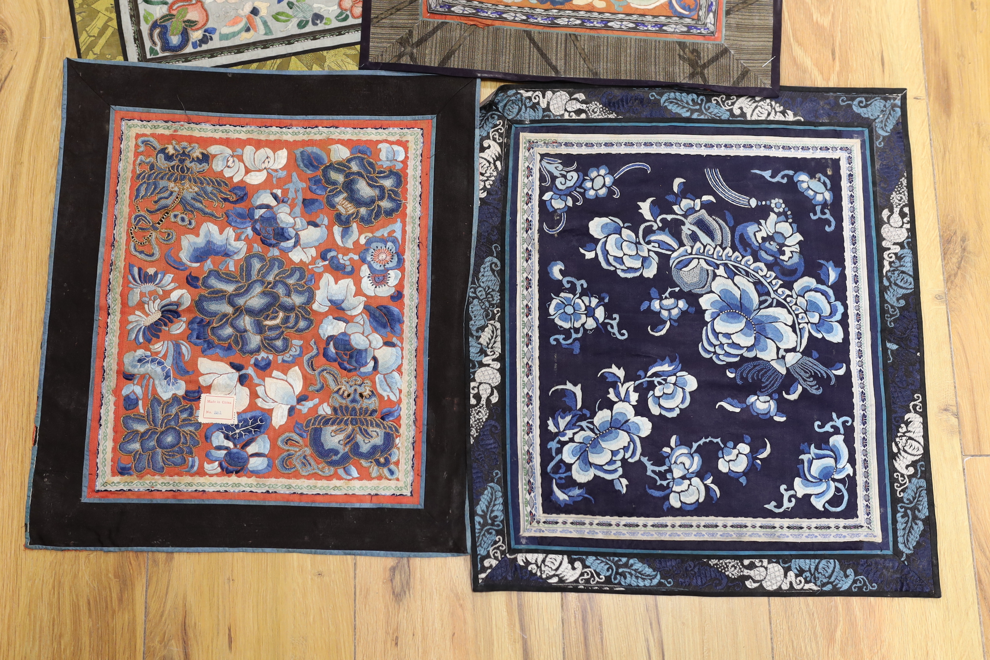 Six panels of Chinese silk embroidered mats, all using mixed stitches including Beijing knot, all bordered with silk brocade, largest 35 x 40cm